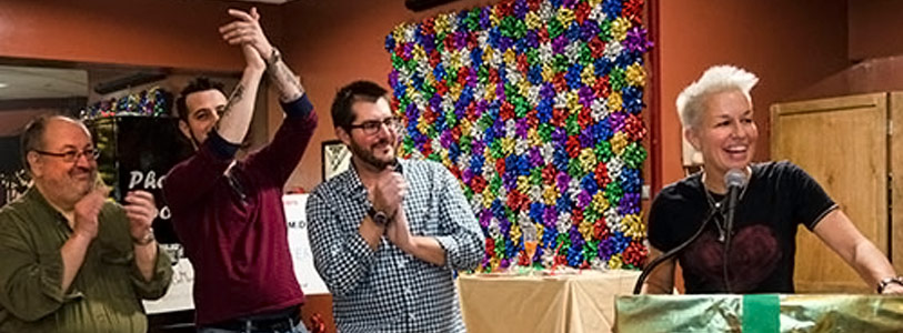 a group of people clapping for a person at the podium