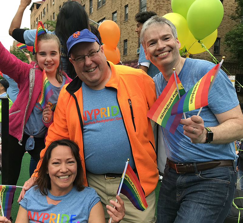 a group of people posing for a photo with balloons