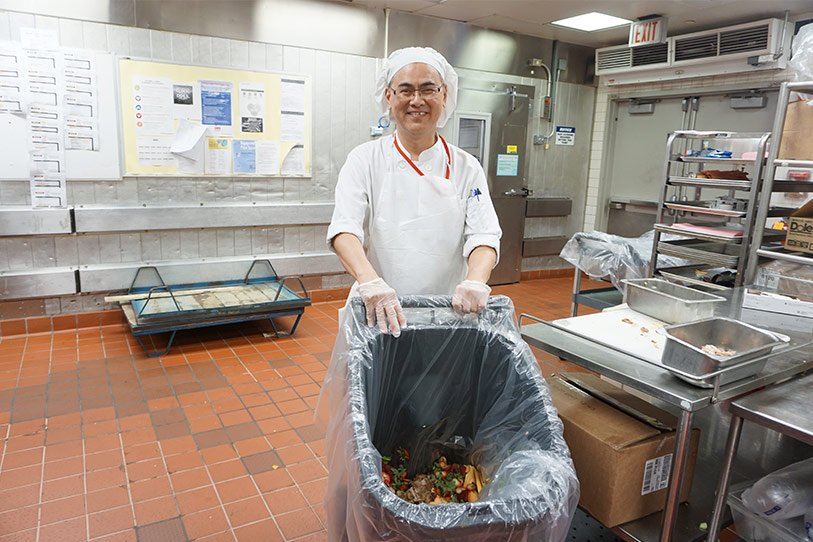 Kitchen worker taking out the trash