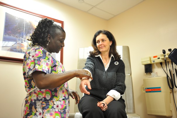 A nurse checking a patients pulse