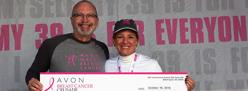 A man and woman holding up a big check 