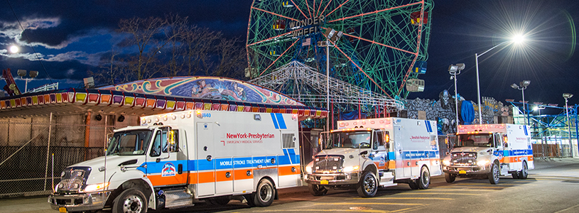 Three ambulances parked at a fair