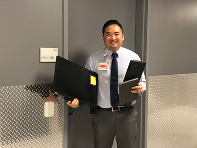 A man holding three devices