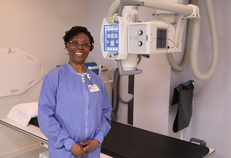 woman standing next to x-ray machine