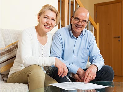 Mature couple signing documents