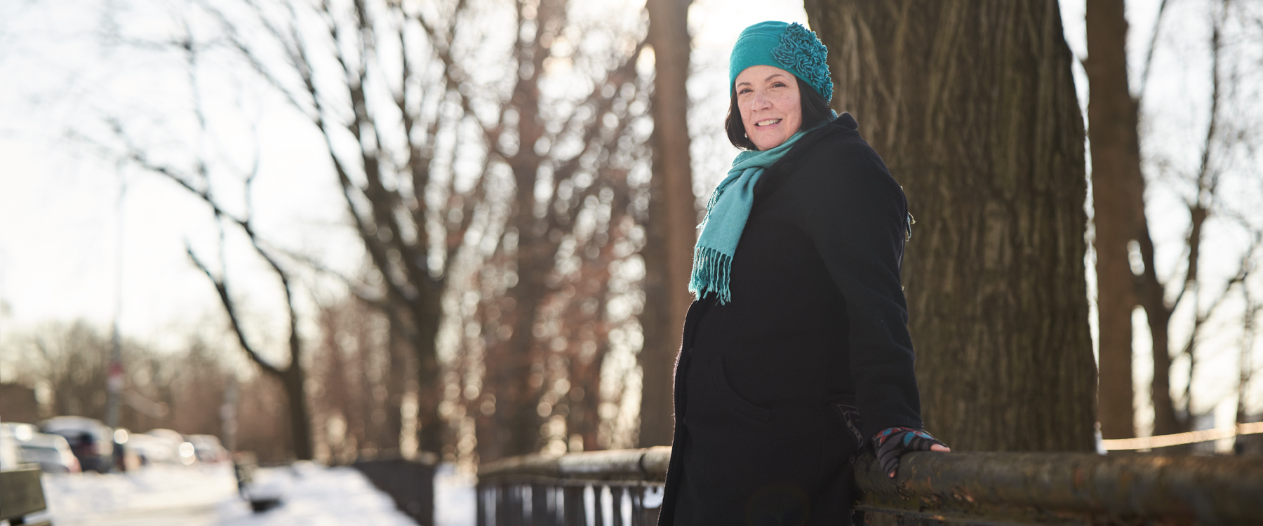 A women standing my a tree on a snowy day