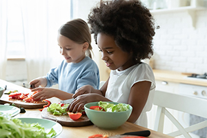 a couple of kids eating food