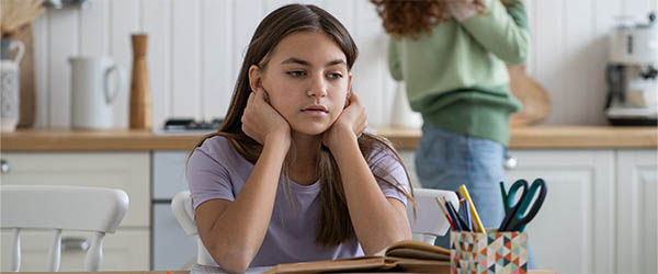 teenager holding her head