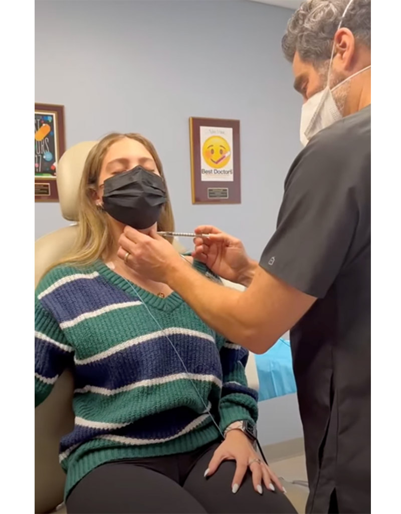 A woman receiving an injection from a physician