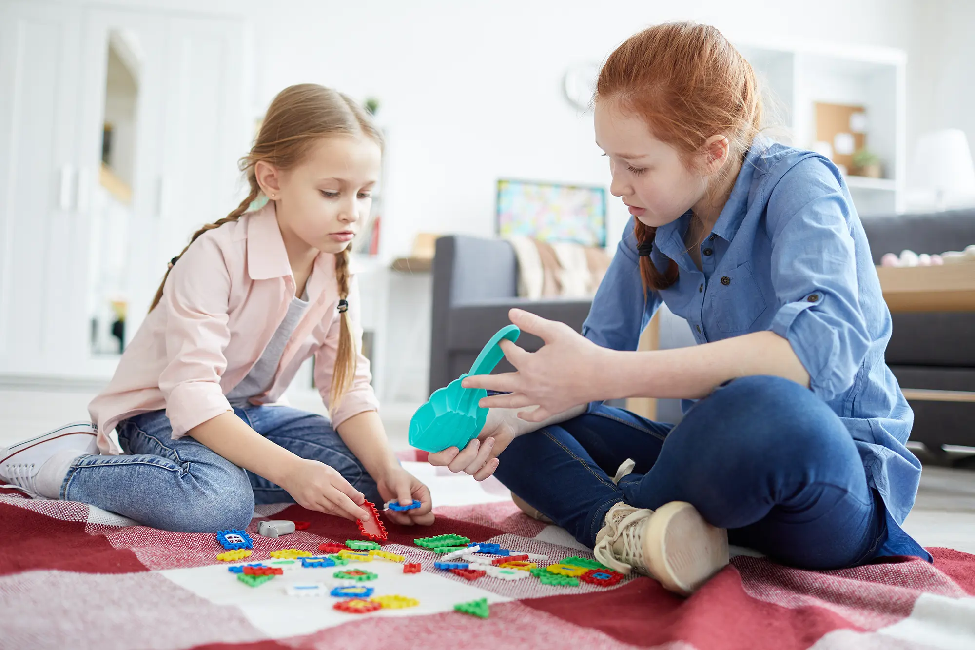 two little girls playing with puzzles