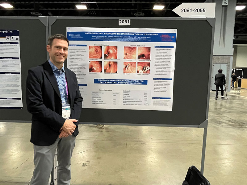 Male physician posing with poster abstract