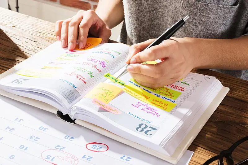 image of person writing in planner